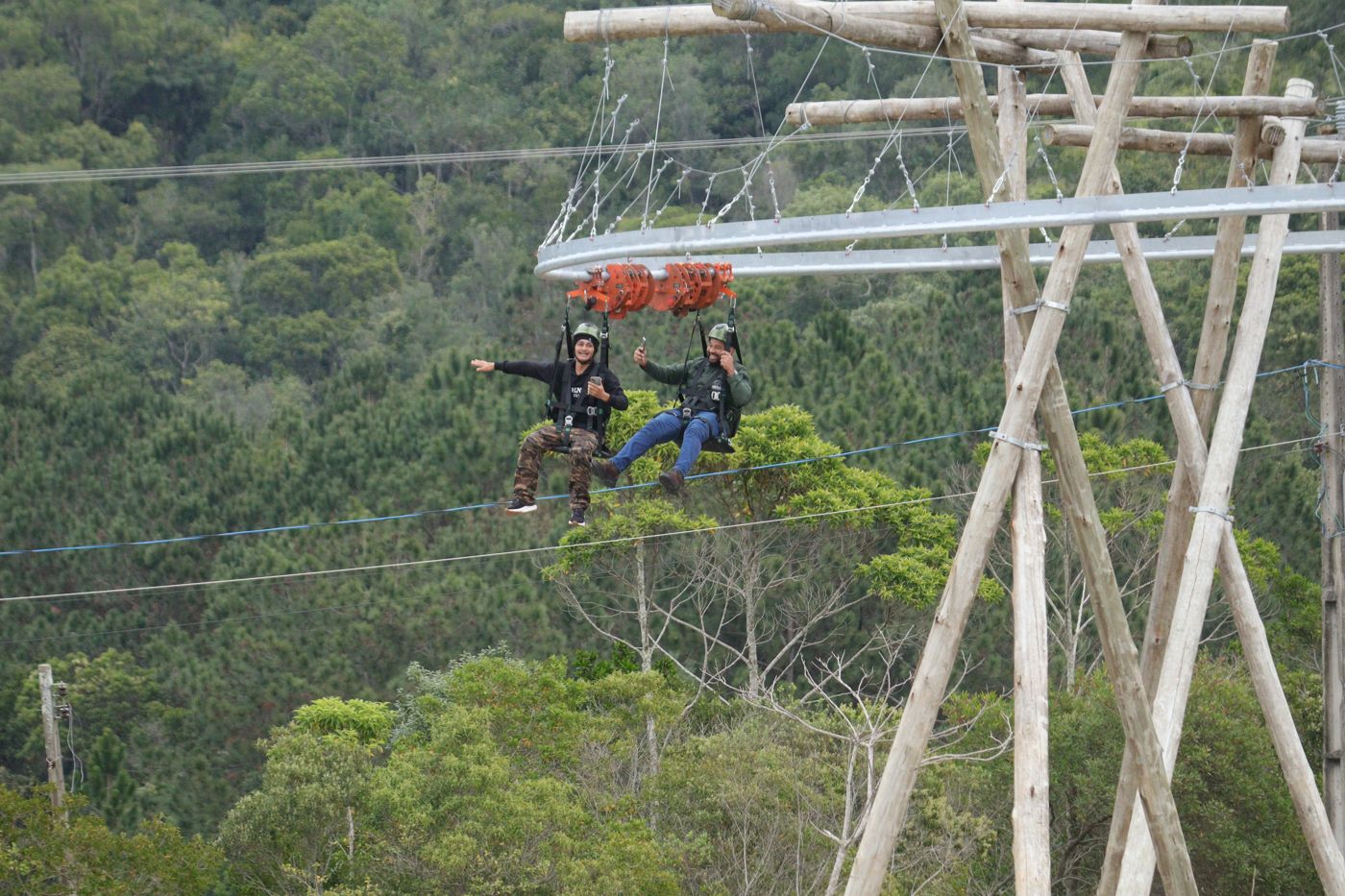 Dois visitantes na Tirolesa Paraquedista sobre a mata
